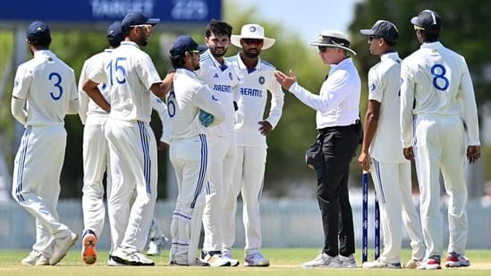 Ishan Kishan and other India A players in conversation with umpire